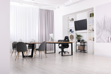 Stylish office with comfortable furniture and tv zone. Interior design