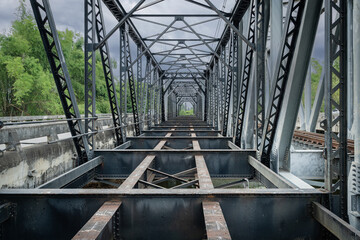 Iron Black Bridge Bridging World Wars I and II which is a railway bridge over the Wang River is a travel history destination and landmark and an important tourist attraction in Lampang. Thailand.