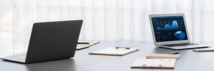 BI data dashboard from Fintech on laptop screen displays comprehensive business analysis in empty office. Technology empowering business financial data visualization and growth strategy. Prodigy