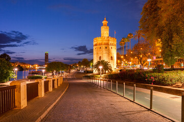 Fototapeta na wymiar Famous watchtower Golden Tower or Torre del Oro and River Guadalquivir at sunset, Seville, Andalusia, Spain