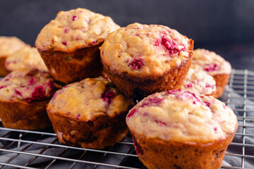 Freshly Baked Raspberry Muffins Piled on a Wire Cooling Rack Side View: Breakfast or dessert muffins made with fruit viewed in profile