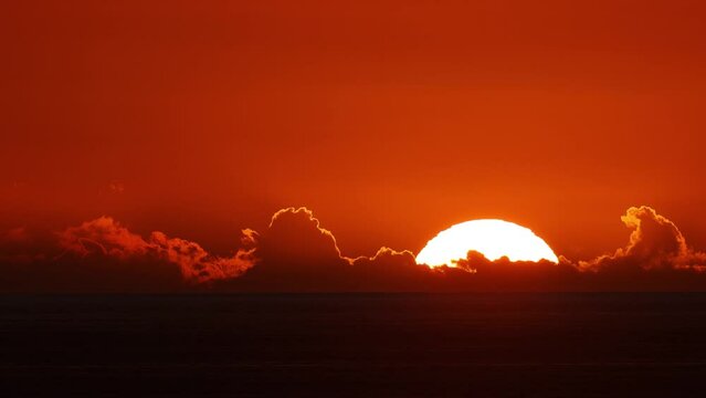 Time lapse of the sun setting over the ocean in Hawaii.