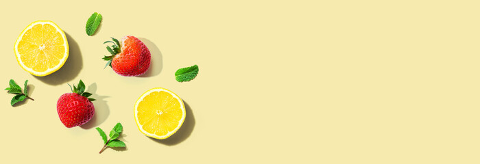 Fresh lemons and strawberries with mints overhead view - flat lay