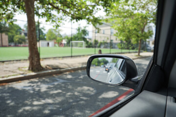 A car mirror reflects the journey ahead, symbolizing self-reflection, perspective, awareness, and the constant pursuit of progress - obrazy, fototapety, plakaty