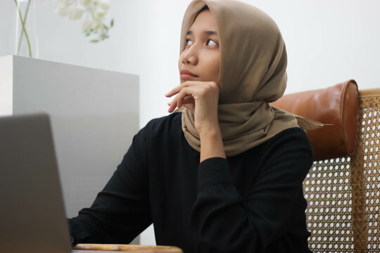 Southeast Asian Hijab-wearing Female Workers Are Thinking About Their Duties.