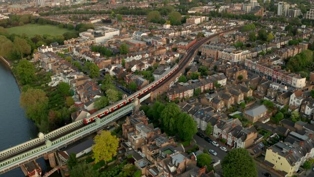 Aerial shot of District line underground train winding through Putney neighbourhood London