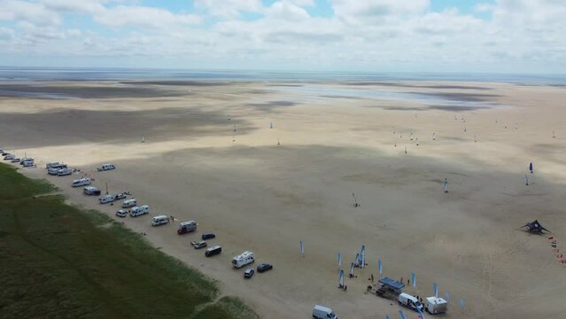 Drone shot beach on coast of Denmark with motorhomes and blokarts