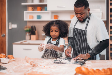 Family members cook homemade pizza dough in funny and playful ways. Mixing ingredients like salt, sugar, milk, yeast, oil then rubbing, massaging, pressing bread flour to make it smoother, stretchier