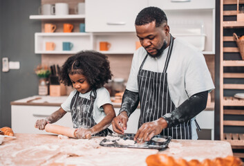 Family members cook homemade pizza dough in funny and playful ways. Mixing ingredients like salt,...