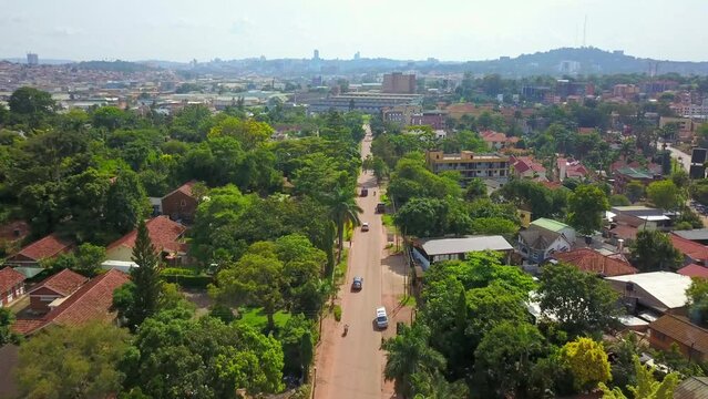 Breathtaking Nature Of Suburban Overview With Vehicles Driving On The Road During Daytime In Bugolobi, Kampala, Uganda. aerial, wide shot