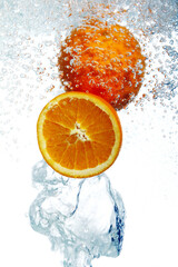 Oranges dropped into water