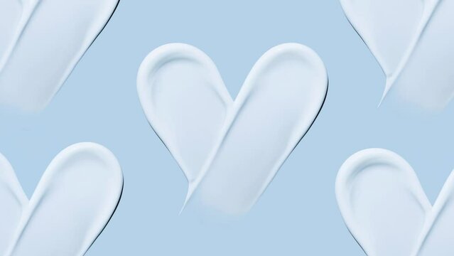 heart shaped cosmetic smear of cream on a blue background