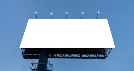 A large mockup of a blank white billboard or white promotional poster appears on the outdoors against a blue sky background.
