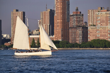 schooner sailboat sailing by a coastal city on the hudson river new york 