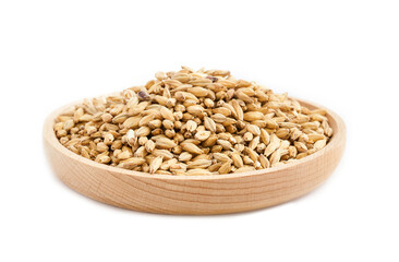 Fototapeta premium malt barley grain beer whole in wood plate isolated on white background. pile of malt barley grain beer whole isolated. heap of malt barley grain beer whole isolated