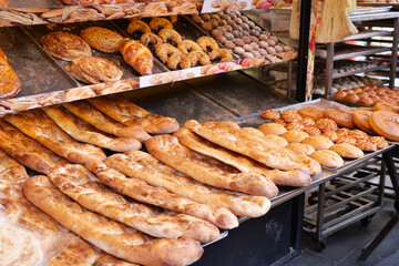 Bread baguettes in a basket in the baking shop