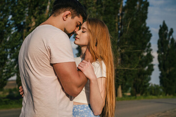 Obraz premium Couple with pensive faces stand close, closed eyes, man with beard holding womans head with tenderness, close up. Rustic portrait.