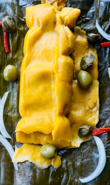 Hallaca typical Venezuelan dish for Christmas dinner. It consists of a cornmeal dough seasoned with chicken and pigmented with onoto or achiote, filled with beef, pork and chicken or chicken stew.