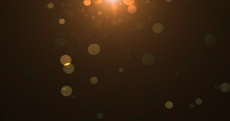 Abstract background of yellow orange gold glowing particles and bokeh dots of festive energy magic