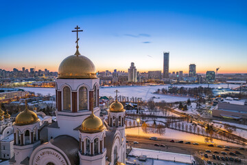 Naklejka premium Winter Yekaterinburg and Temple on Blood in beautiful blue clear sunset. Aerial view of Yekaterinburg, Russia. Translation of the text on the temple: Honest to the Lord is the death of His saints.