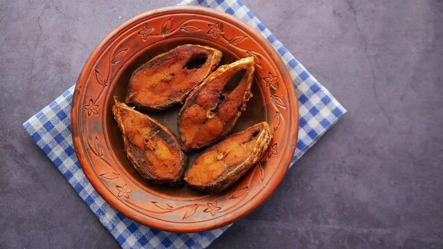 close up of cooked ilsha fish on plate on table 