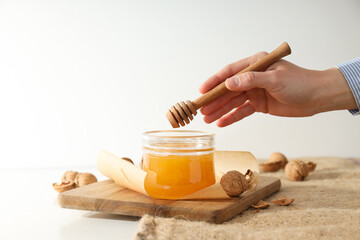 Concept of tasty and sweet food - honey with nuts