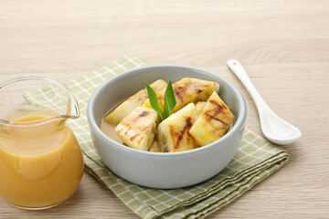 Pisang Gapit or Pisang Epe, grilled banana with palm sugar sauce. Indonesian traditional food.
