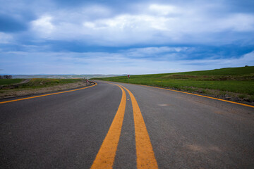 Beautiful empty winding road with signpost