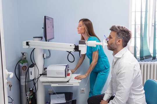 Man testing breathing function by spirometry. Diagnosis of respiratory function in pulmonary disease
