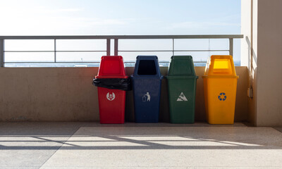 Separate bins for each type of waste. Placed on a tall building