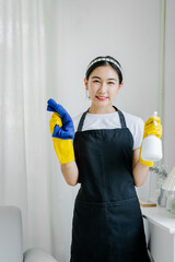 Young women use cleaning cloths and disinfectant sprays to wipe tables and mop floors in the house. cleaning staff cleaning maid