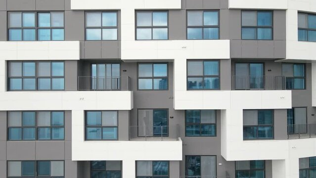 Modern gray building of residential complex close-up, urban geometry.