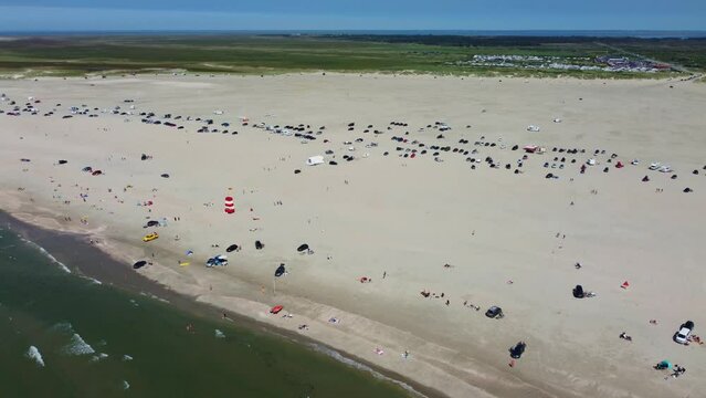 Drone shot busy crowded beach on coast of Romo Island in Denmark