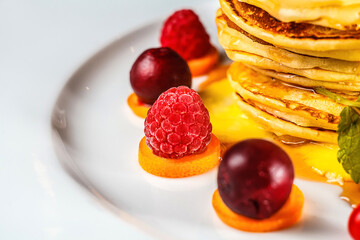 A fresh and sweet breakfast dish of succulent berries atop a fluffy pancake, the perfect start to a healthy day.