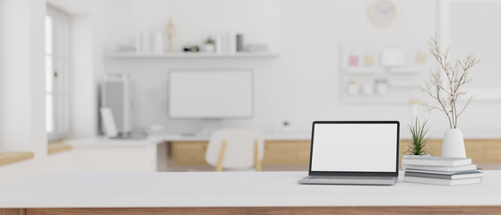 Minimalist workspace with laptop mockup on a white table in a cozy minimal office.