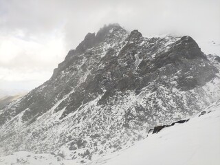 Fototapeta na wymiar White snow mountain rocks in alps day time