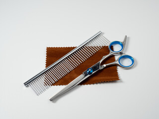 Scissors and comb for grooming dogs. Dog grooming kit. Close-up of a dog grooming tool.