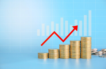 Stack of golden money coin on blue background with graph and red up arrow. Business, money and financial background. 