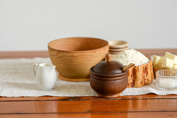 Handmade natural color wooden utensils on a wooden table