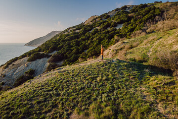 Aerial view of mountains with traveller and evergreen trees with evening light