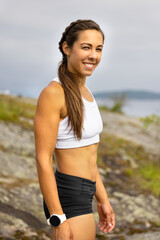 Fit smiling woman taking a break during outdoor workout