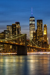 New York City skyline of Manhattan with Brooklyn Bridge and World Trade Center skyscraper at twilight portrait format in the United States