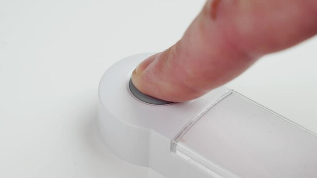 Patient hand pressing emergency nurse call button for help close up. Assistance concept