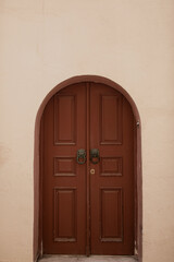 Old ancient colourful textured door in a stone wall in Greece, Crete. Vintage doorway. Traditional European, Greek architecture. Summer travel