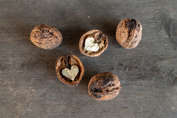 Walnuts on rustic wooden background, top view. Healthy food.