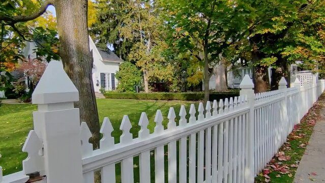 View of a small town in Canada with white picket fence in autumn