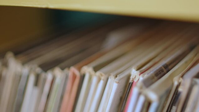 Edges Of Vinyl Records Stacked In The Shelf. closeup, sideways