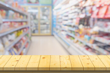 Empty wood table top with supermarket blurred background for product display