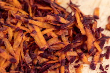Sliced into thin slices of red-orange carrots in the kitchen
