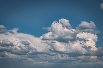 Thunderclouds gather over the road leading along the fields, creating a very magical landscape.